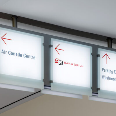 Ceiling sign arrows pointing to Air Canada Centre, Bar & Grill and Parking Elevator